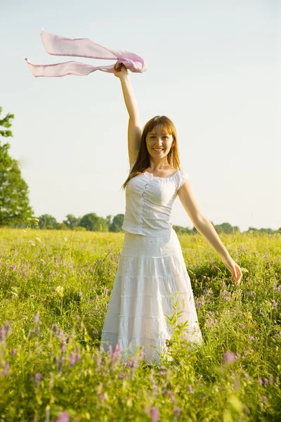 Girl standing on meadow grass Stock Photo
