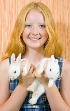 Girl with two pet rabbits clipart