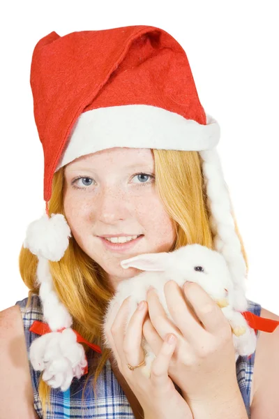 Meisje in Kerstman hoed met konijn — Stockfoto