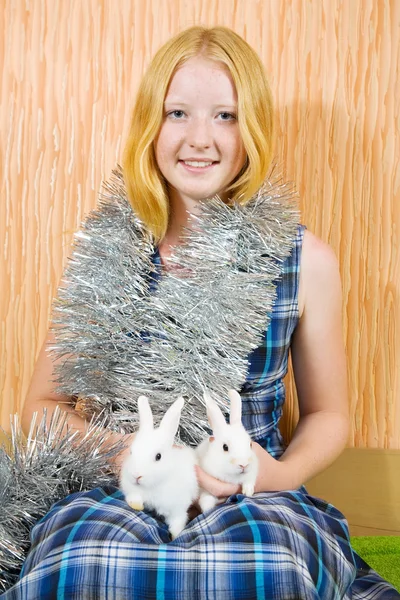 Girl in clinquant with two rabbits — Stock Photo, Image