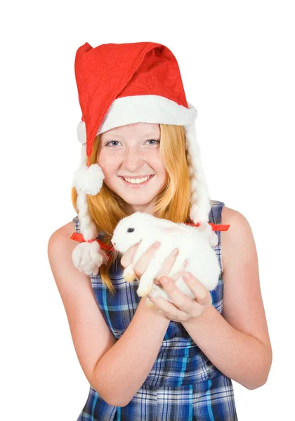Meisje in Kerstman hoed met huisdier konijn — Stockfoto