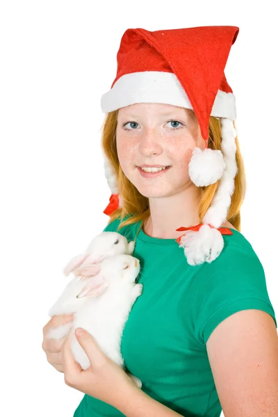 Meisje in Kerstman hoed met konijnen — Stockfoto