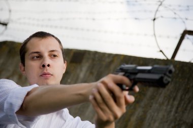 Man aiming a black gun clipart