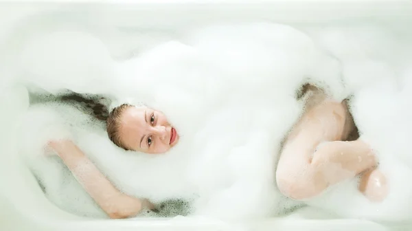 Girl laying with foam — Stock Photo, Image