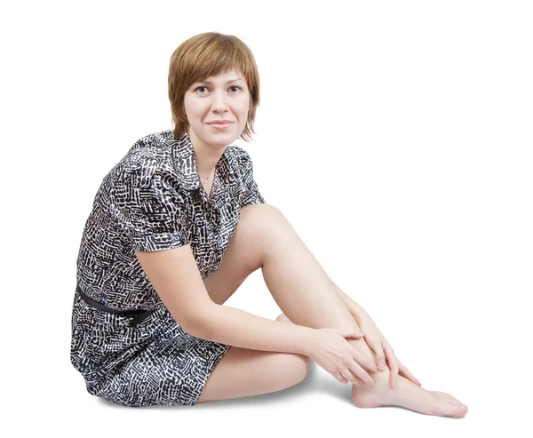Сидящая девушка в сексуальном платье — стоковое фото