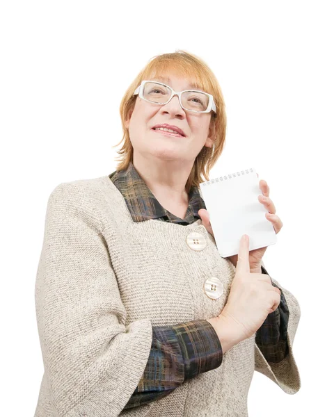 Senior woman pointing on empty notebook — Stock Photo, Image