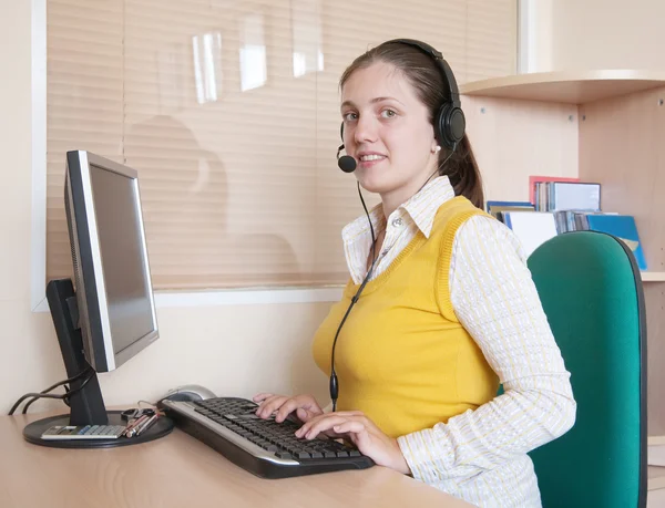 Mujer de negocios comunicándose en auriculares y sonriendo —  Fotos de Stock