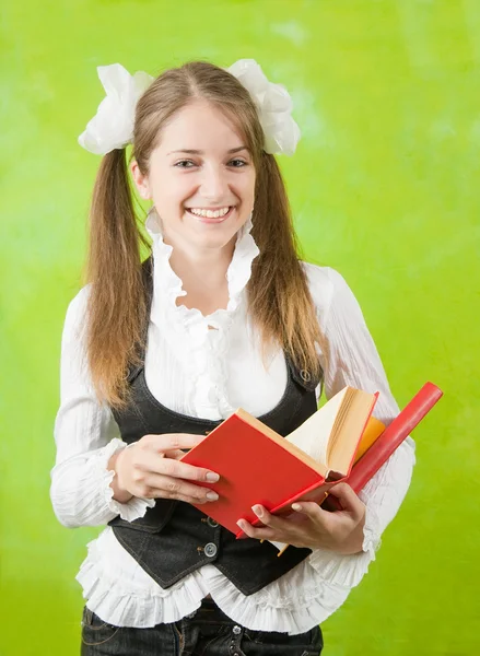 Schoolgirl reading red book — Stock Photo, Image