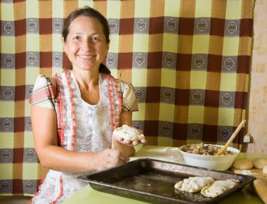 Woman making meat dumplings clipart