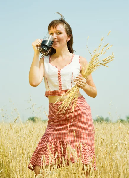 Girl with quass and wheat ears — Stock Photo, Image