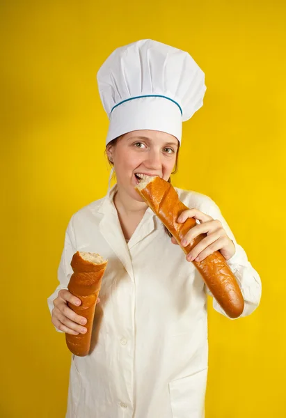 Baker is testing long bread — Stock Photo, Image