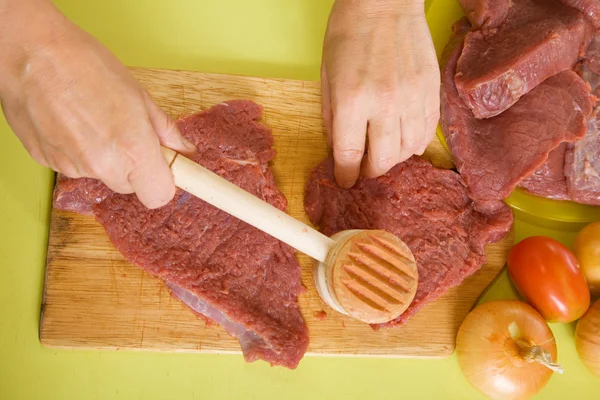 Cook hands making tenderized steak — Stock Photo, Image