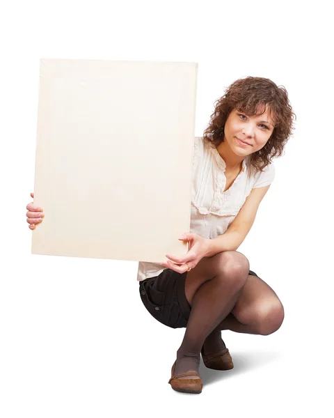Chica sostiene lienzo en blanco —  Fotos de Stock