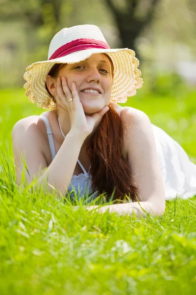 Girl in hat on grass — Stock Photo, Image