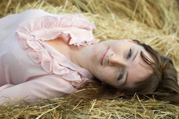 Girl resting on hay — Stock Photo, Image
