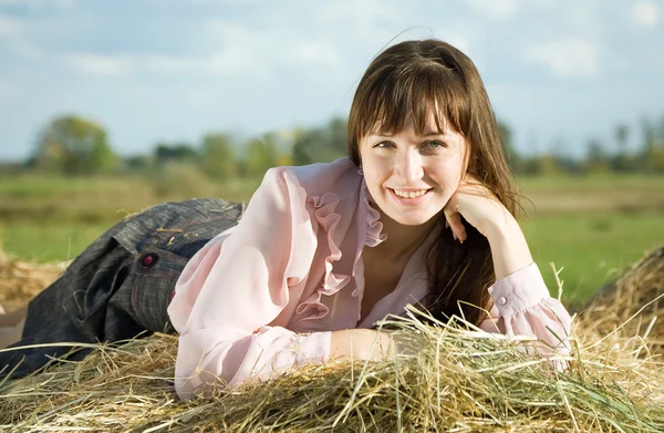 Girl on hay in summer — Stock Photo, Image