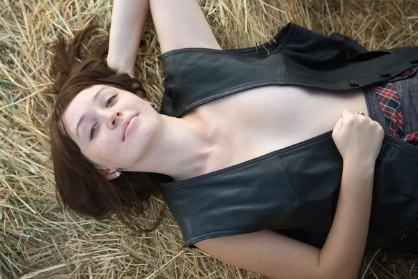 Girl resting on hay — Stock Photo, Image