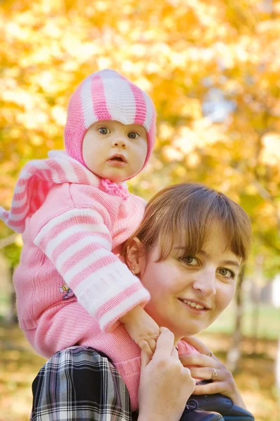 Mother with baby outdoor in autumn — Stock Photo, Image