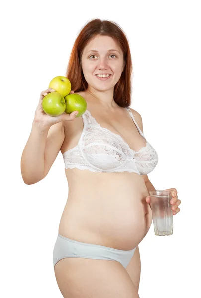 Mulher grávida com água e maçãs — Fotografia de Stock
