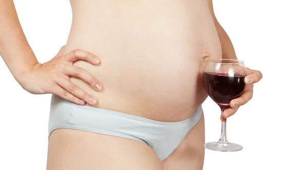 Pregnant woman holding wine — Stock fotografie