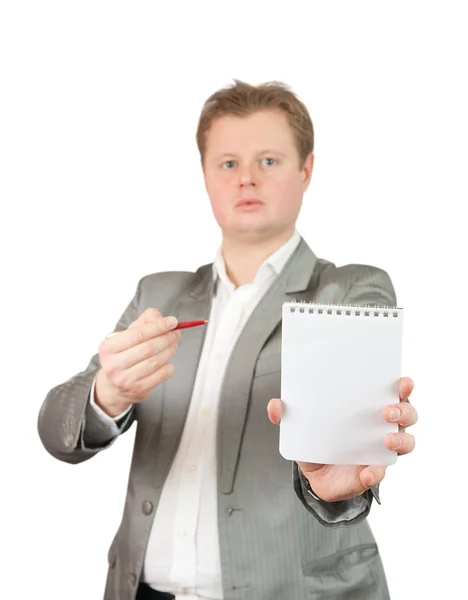 Empresário apontando para caderno em branco — Fotografia de Stock