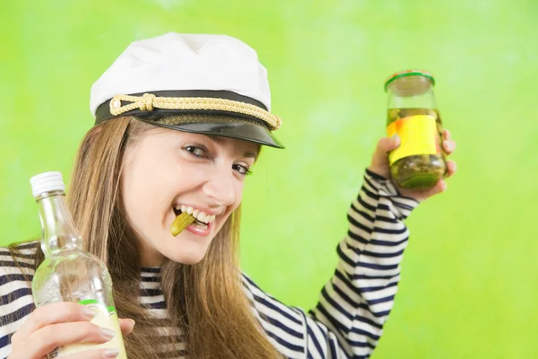 Female sailor with bottle of vodka and pickle — Stock Photo, Image