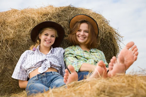 Girls restings on hay — Stock Photo, Image