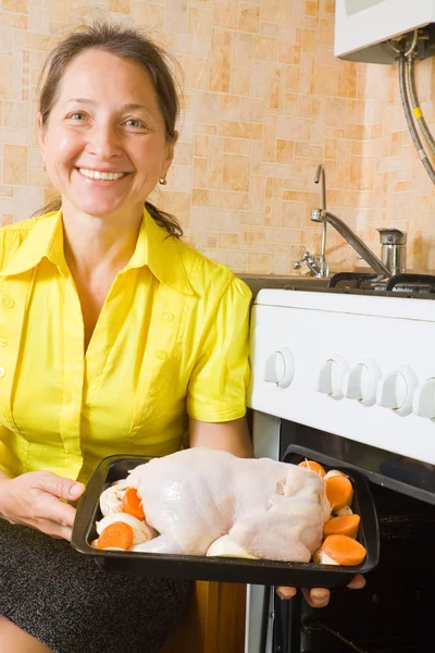 Woman roasting stuffed chicken — Stock Photo, Image