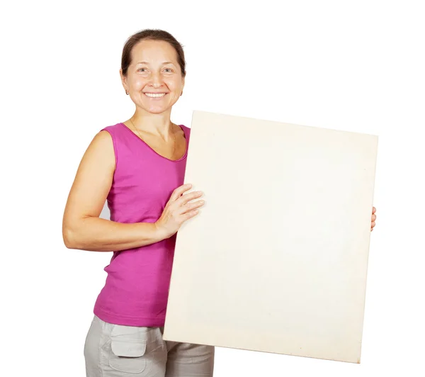 Mature woman holds blank canvas — Stock Photo, Image