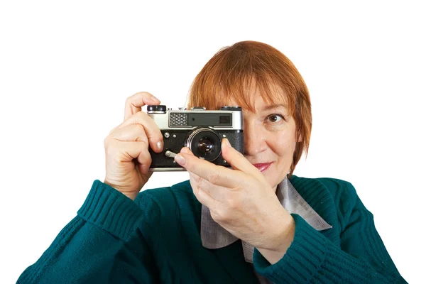 stock image Senior woman taking photo with vintage camera over white background