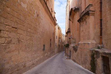 Old narrow street of european town (Mdina, Malta) clipart