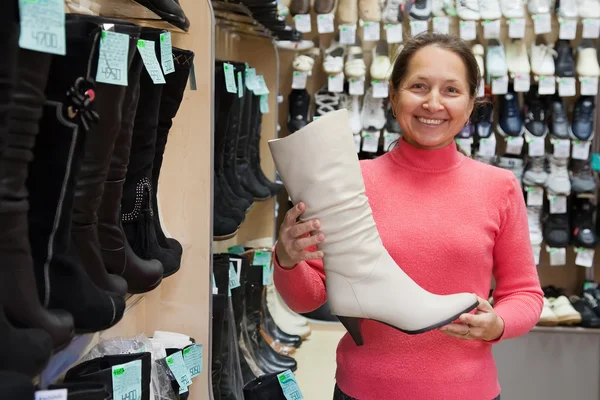Mature Woman Chooses High Boots Shoes Shop — Stock Photo, Image