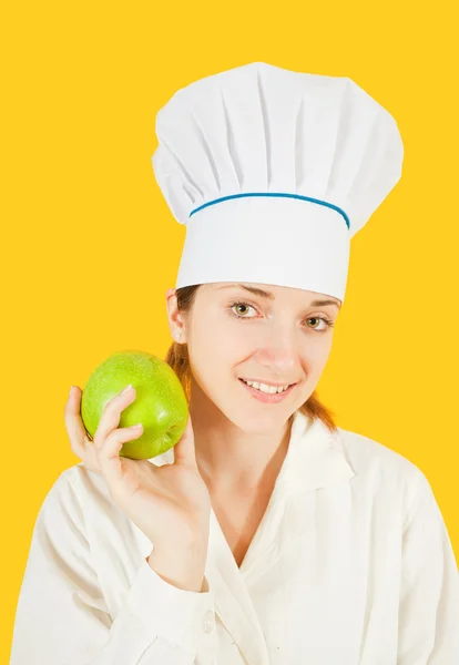 Female Cook Holding Green Apple Yellow Background — Stock Photo, Image