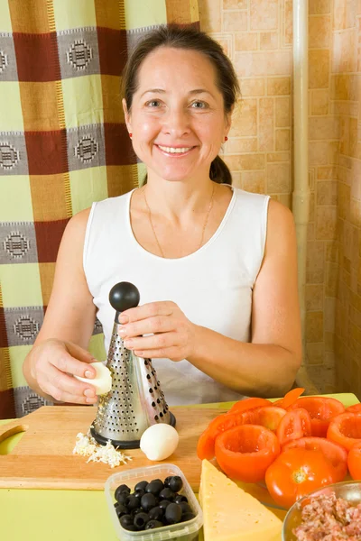 Woman grating eggs — Stock Photo, Image