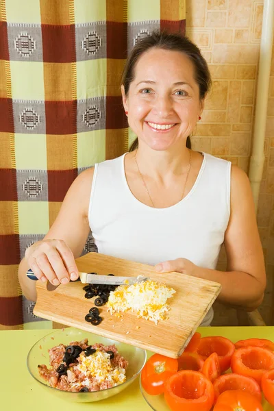 Mature Woman Adds Grated Eggs Sliced Olives Mincemeat See Series — Stock Photo, Image
