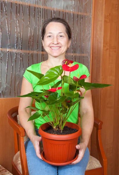 Mature woman with anthurium — Stock Photo, Image