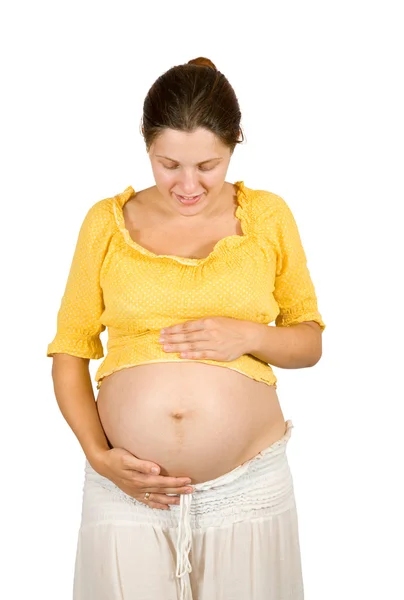Těhotná žena hledá břicho — Stock fotografie