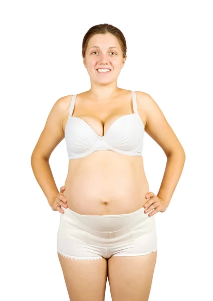 Беременная женщина одевает пояс для беременных — стоковое фото