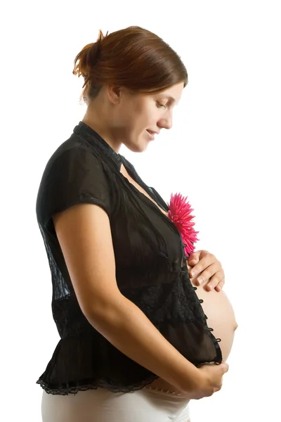 Těhotná žena s květem nad bílá — Stock fotografie
