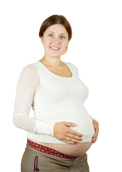 怀孕的女孩抱着她的肚子 被雪白的身体包裹着 被剪断了路径 — 图库照片