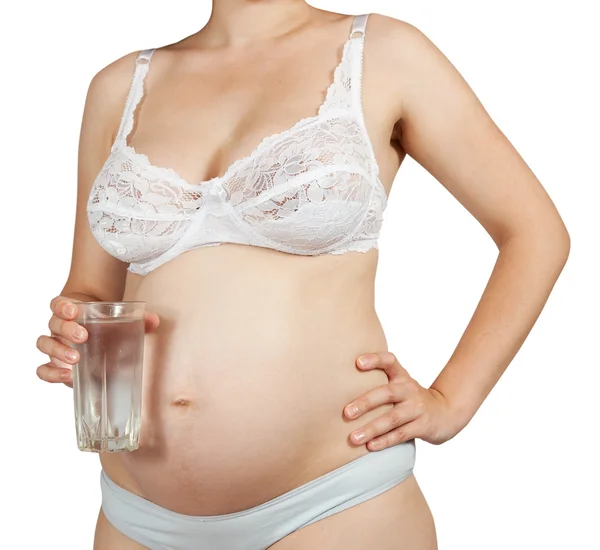 Donna incinta con bicchiere d'acqua — Foto Stock