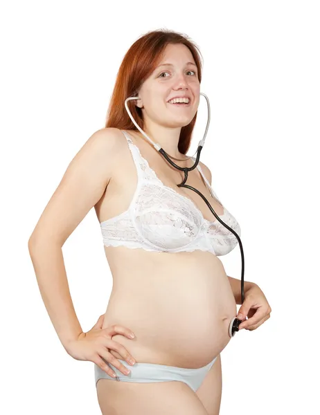 Pregnant woman listening to belly — Stock Photo, Image