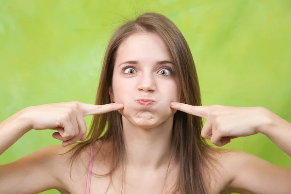 Girl Puffs Her Cheeks Green Background — Stock Photo, Image