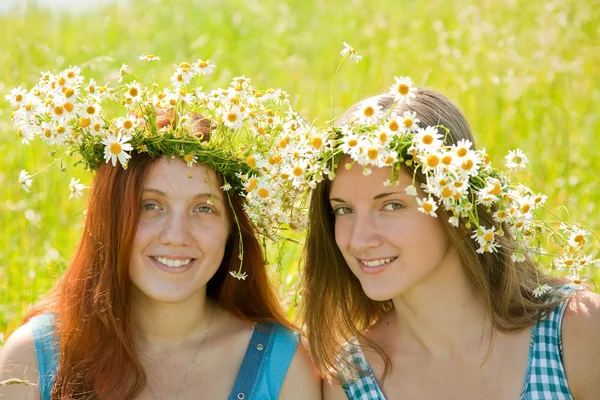 Girls in camomile wreaths — Stock Photo, Image