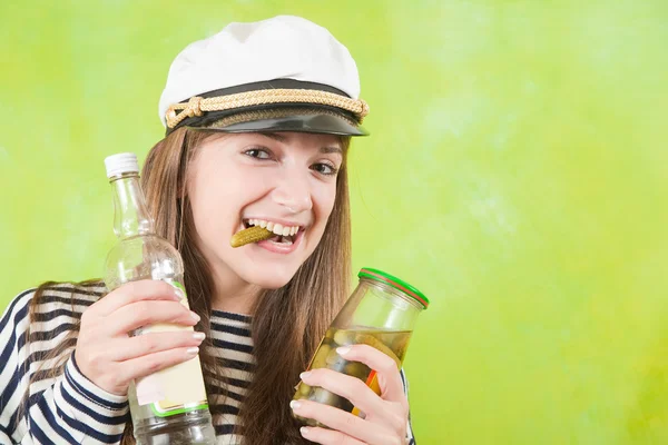 Female sailor with bottle of vodka and pickle — Stock Photo, Image
