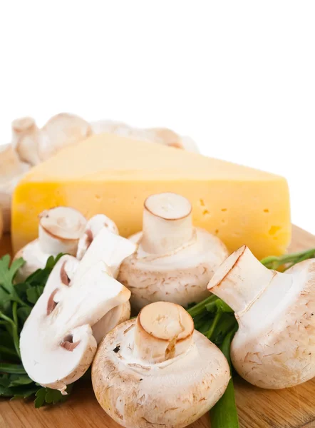 stock image Closeup of champignon mushroom with cheese on cutting board over white