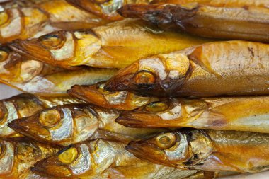 Background of golden smoke-dried fish close up clipart