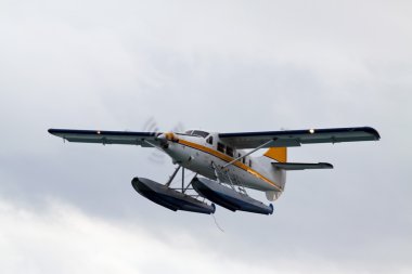 Small hydroplane in air against blue sky clipart