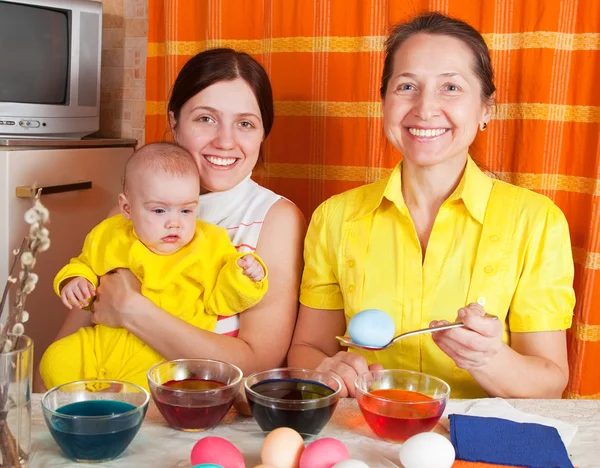 Happy family coloring easter eggs — Stock Photo, Image