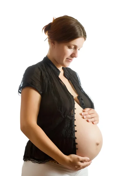 Femme enceinte regardant ventre — Photo